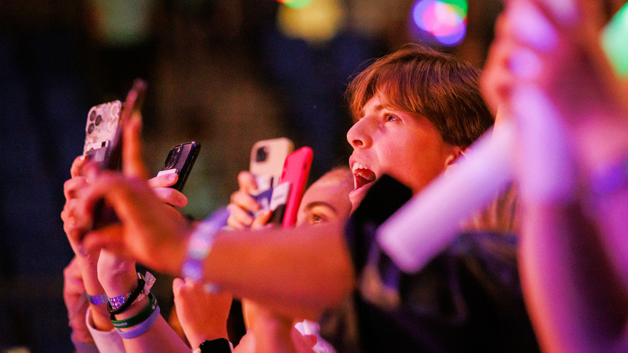 A student screams in the crowd while recording on his phone at Wake the Giant during Offset's performance