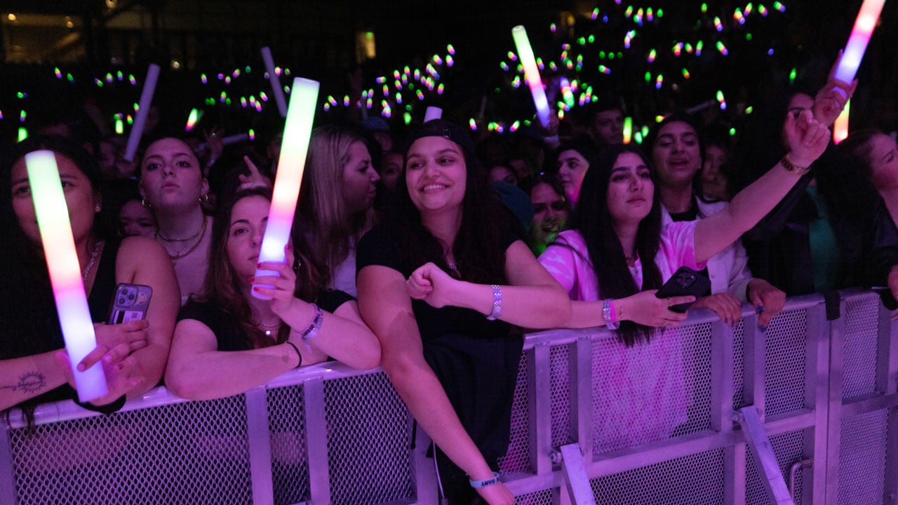 Students hold up glow sticks at Wake the Giant during Offset's performance