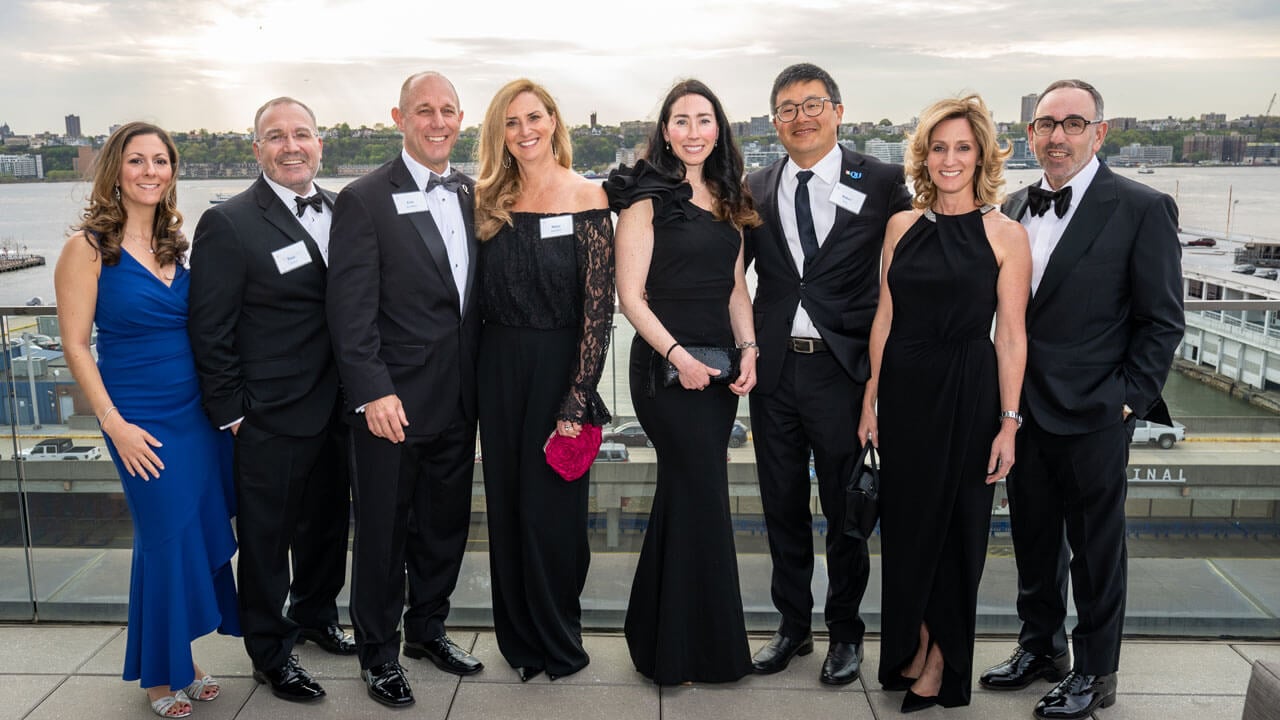 Eight people pose for a photo