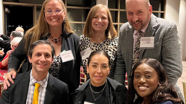 Quinnipiac Law alumni posing for a picture at an event