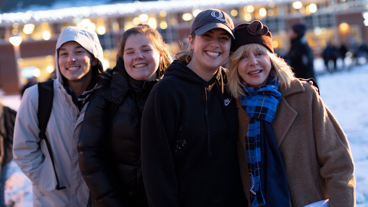Judy Olian poses for a photo with students