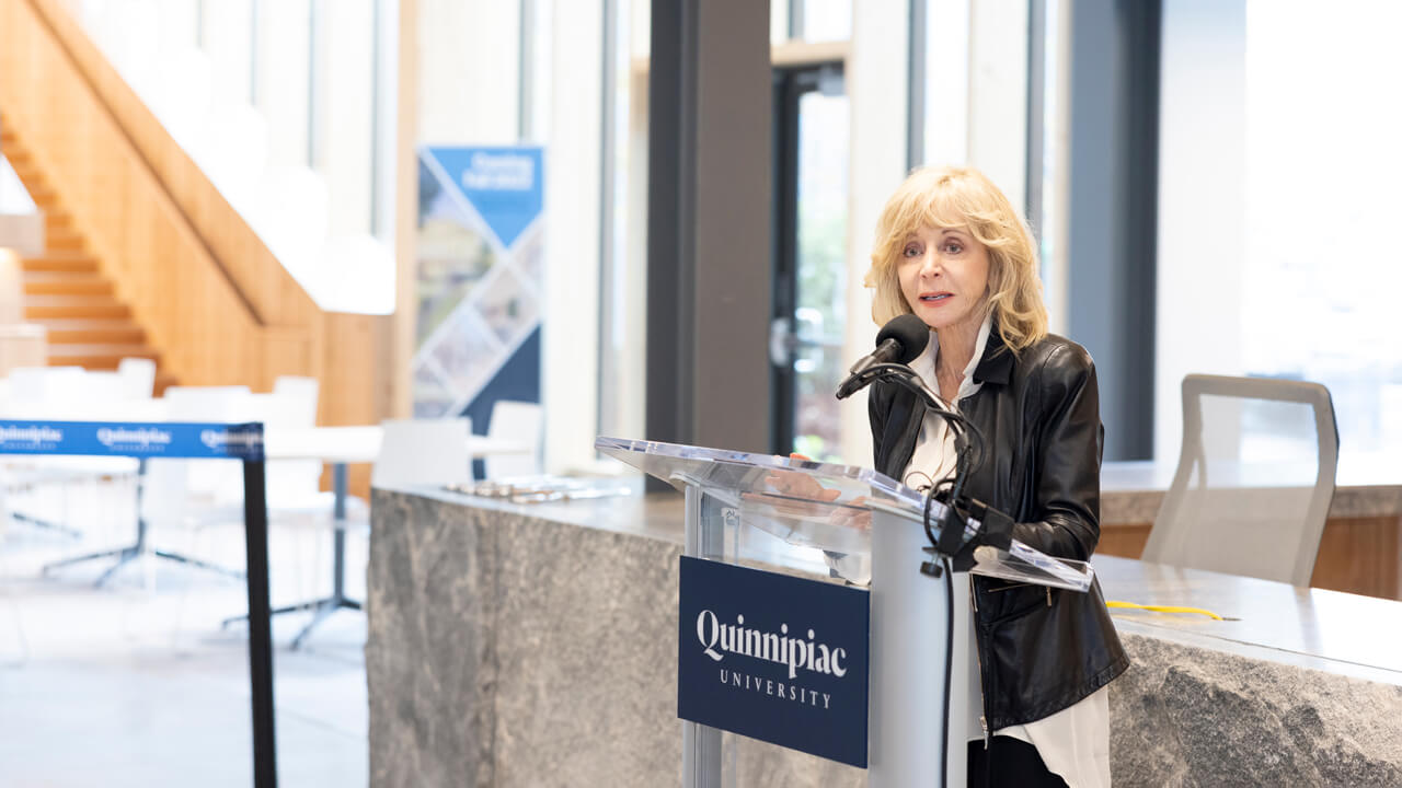Judy Olian speaks at a podium