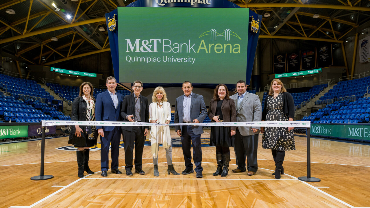 Judy Olian cuts a ribbon