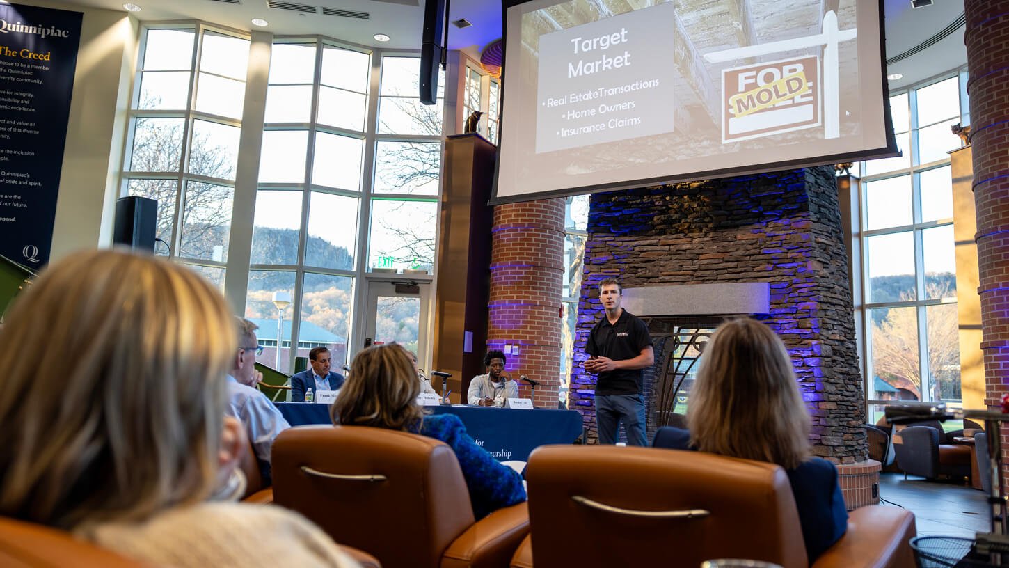 Students watch their peers participating in the pitch competition.