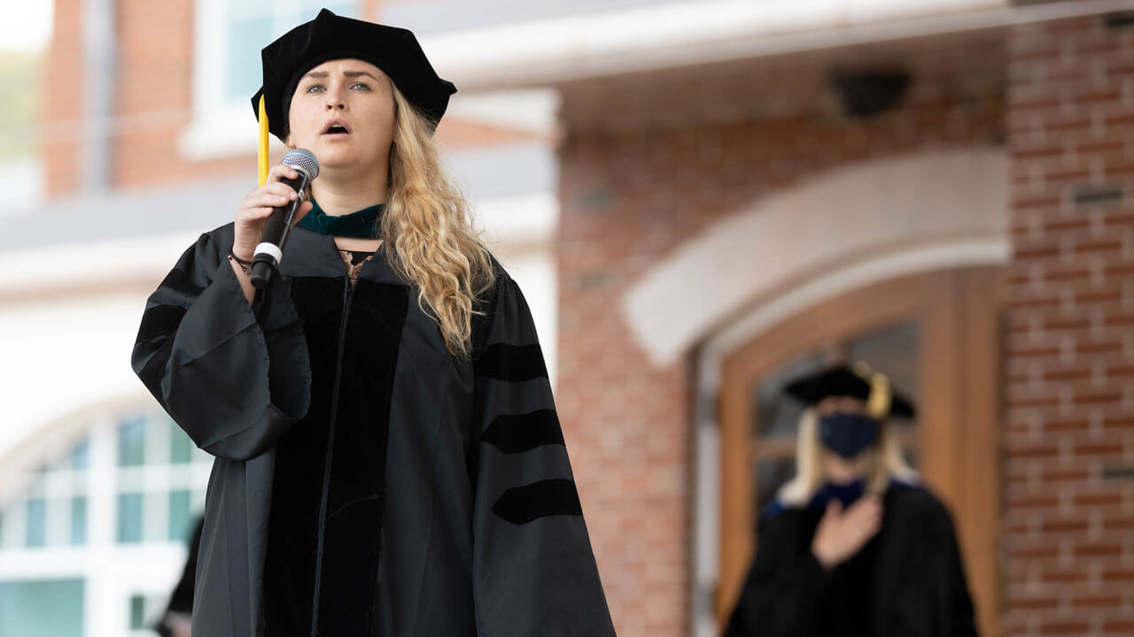 Caroline J. Ringle sings National Anthem during commencement ceremony