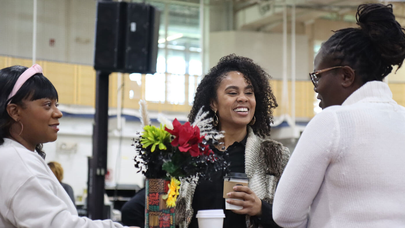 Students chat and network during a pop-up shop event.