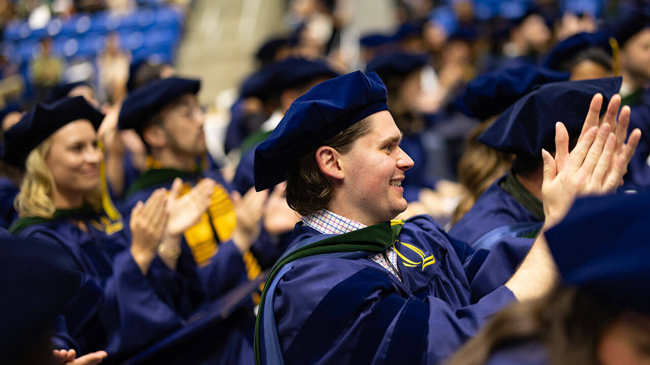 Graduates clapping in the crowd