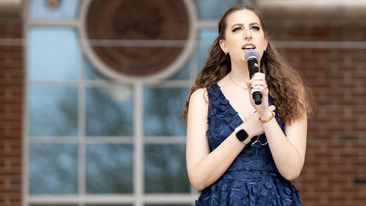 Julia Orlofski singing during the commencement ceremony