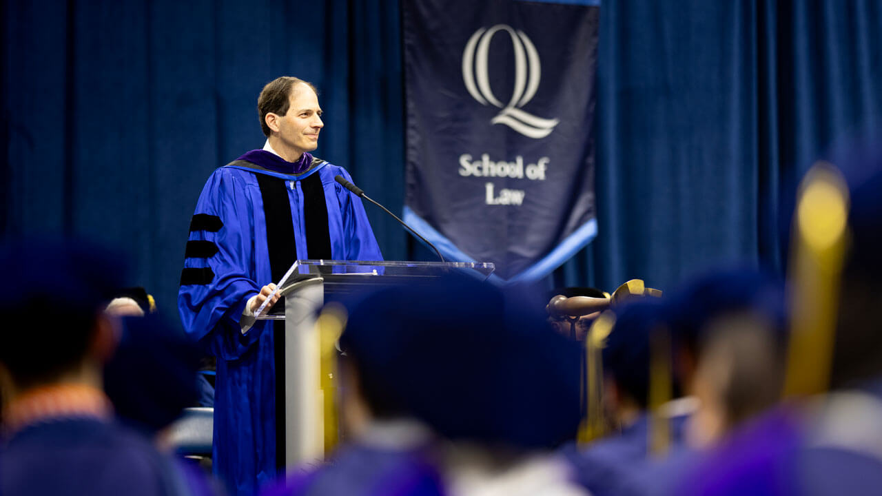 Professor of the Year, Jeffrey Cooper, addresses graduates from the stage.