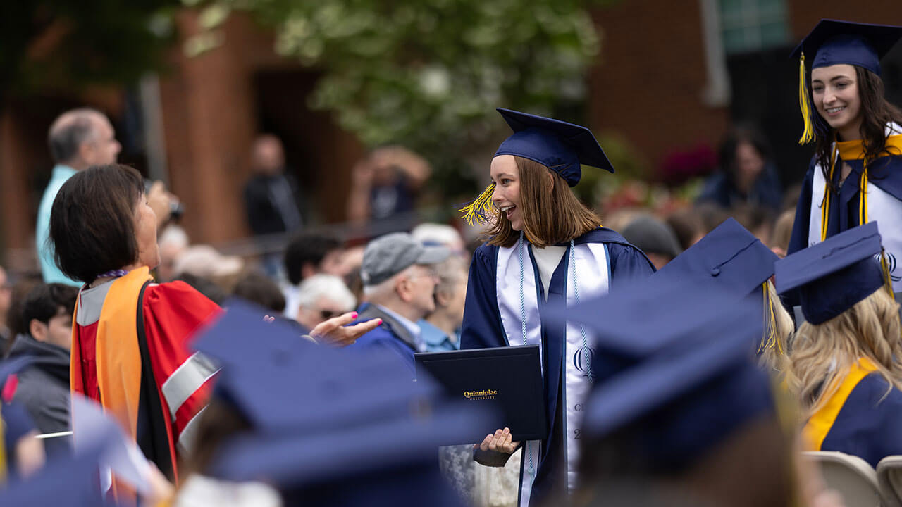 graduate grins at professor