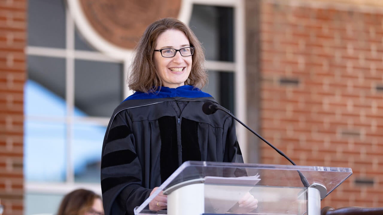 Adele Merrit, PhD smiles into the crowd