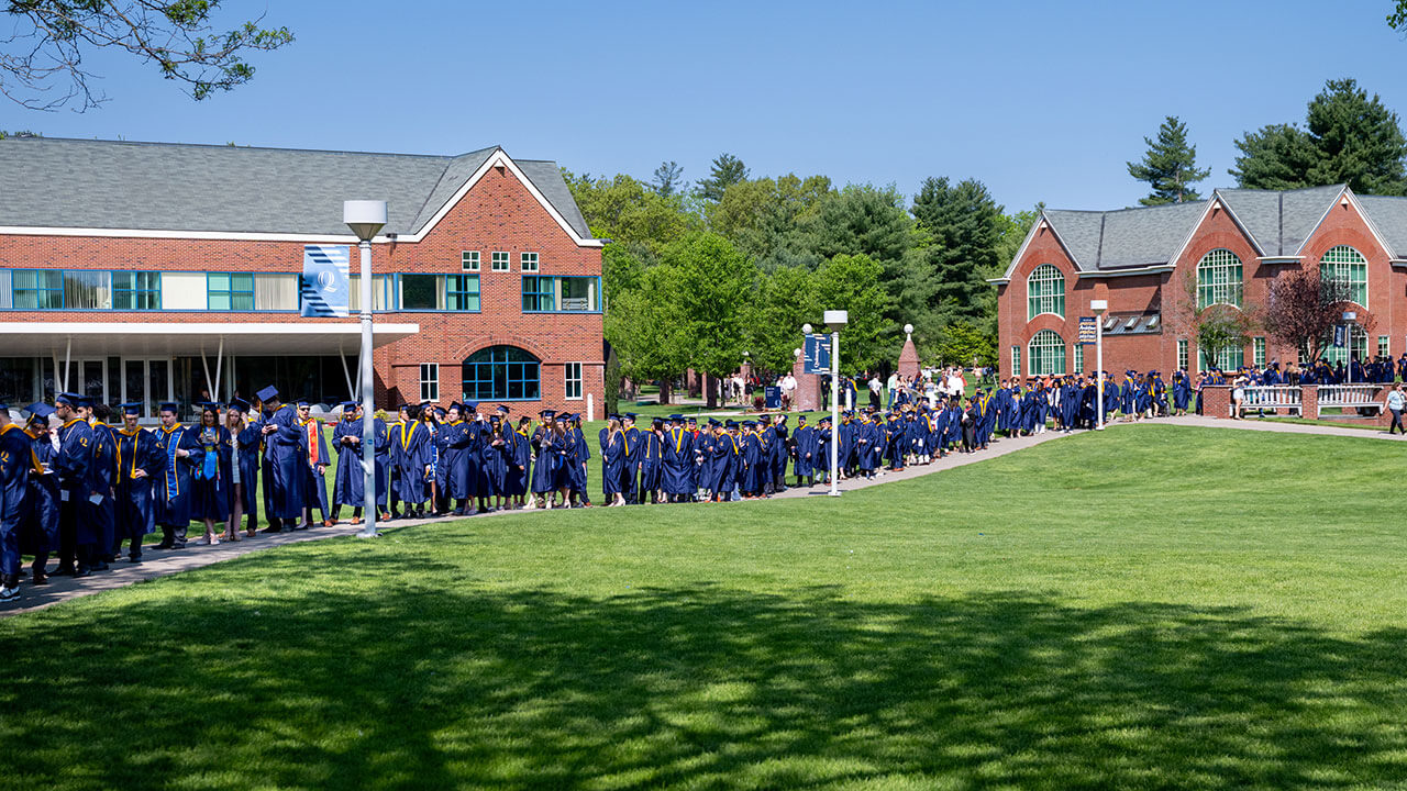 A line of Quinnipiac graduates wrap around the quad
