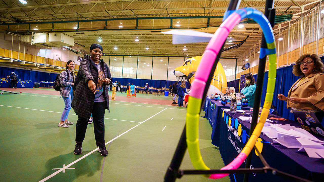 Student plays a game at the Commencement Fair