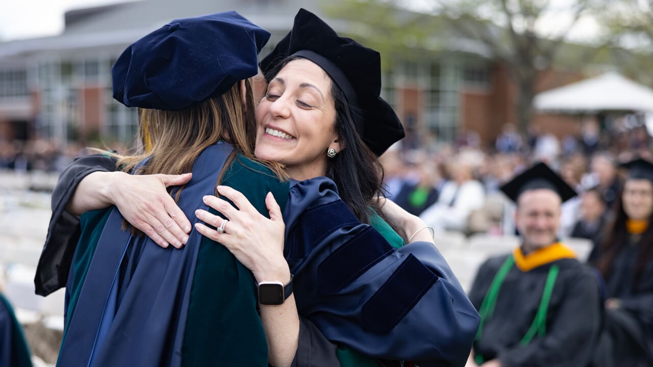 Student hugs professor