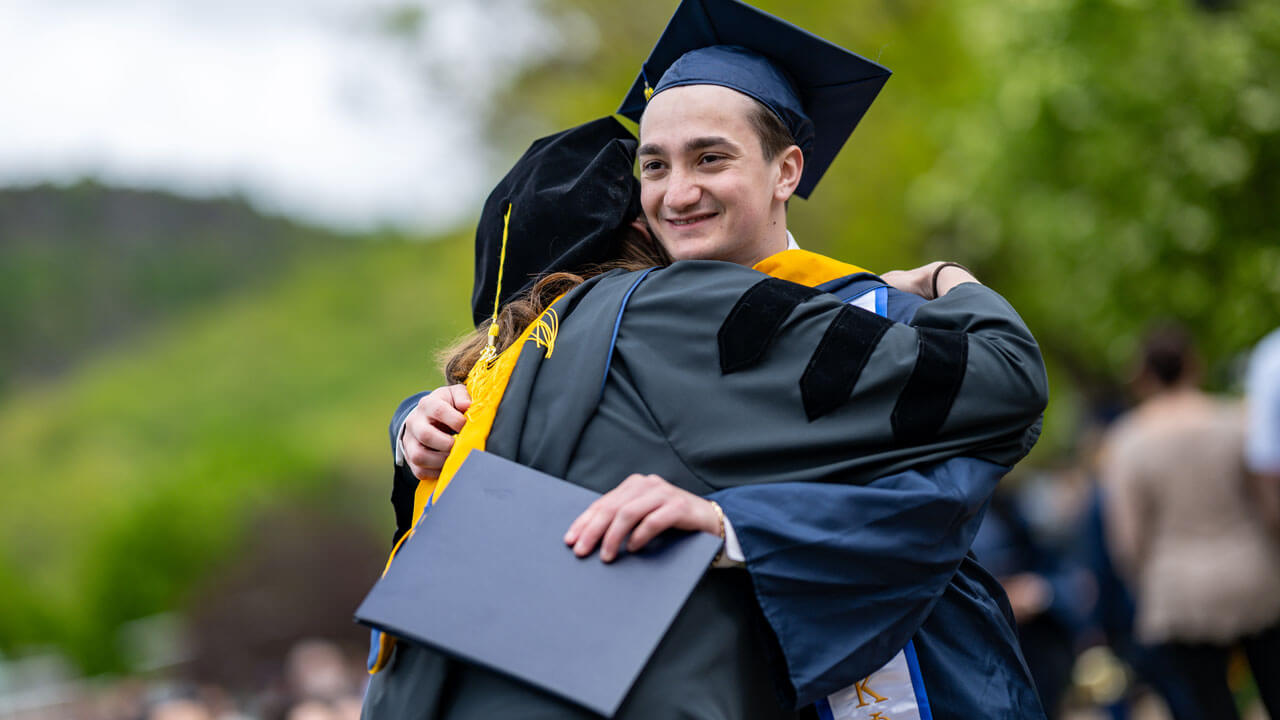 Graduate hugging a professor