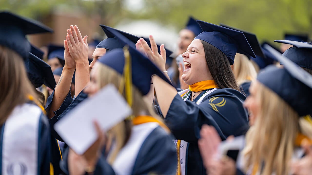 nursing graduates cheer and applaud