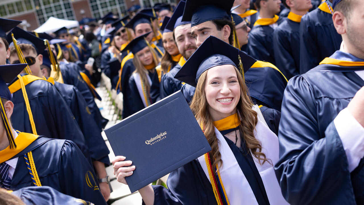 Student poses with degree