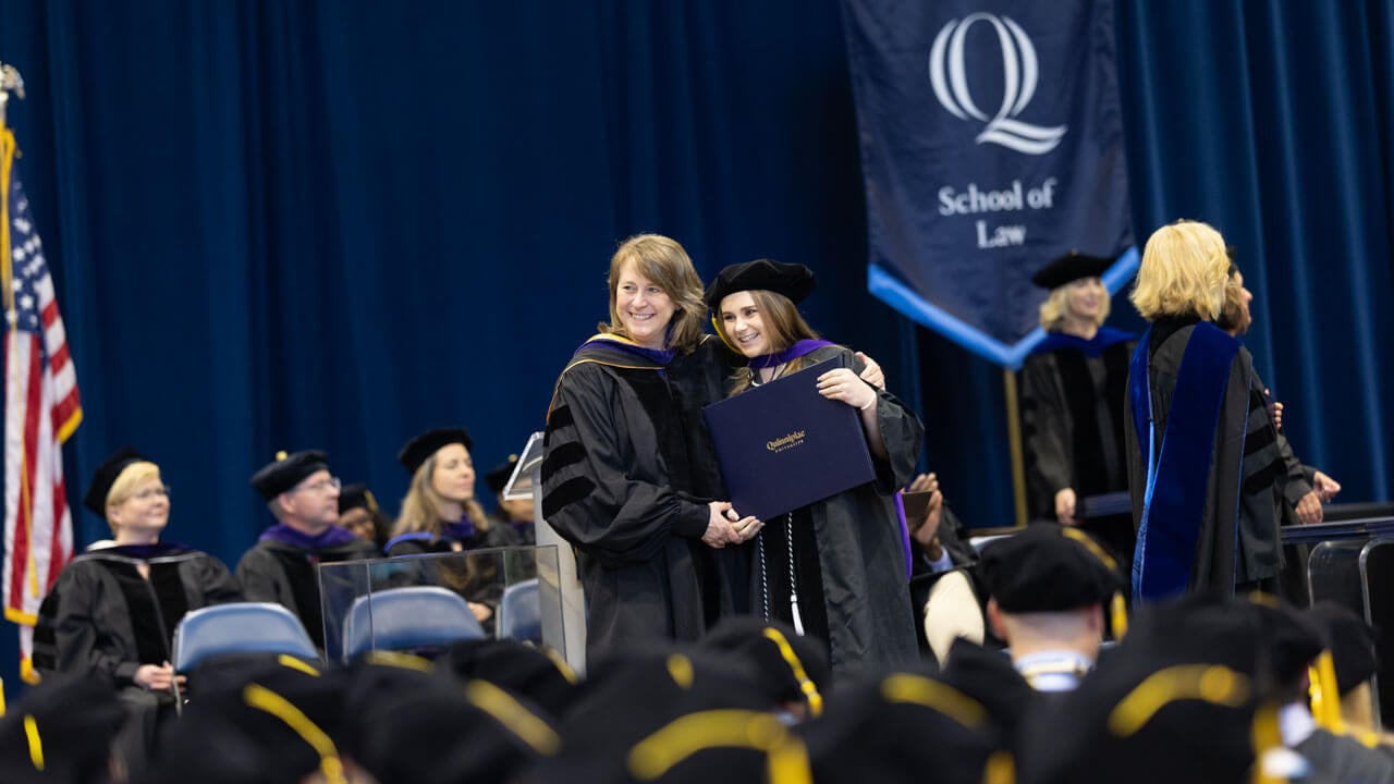 Student smiling and posing for a photo with Dean Jennifer Brown