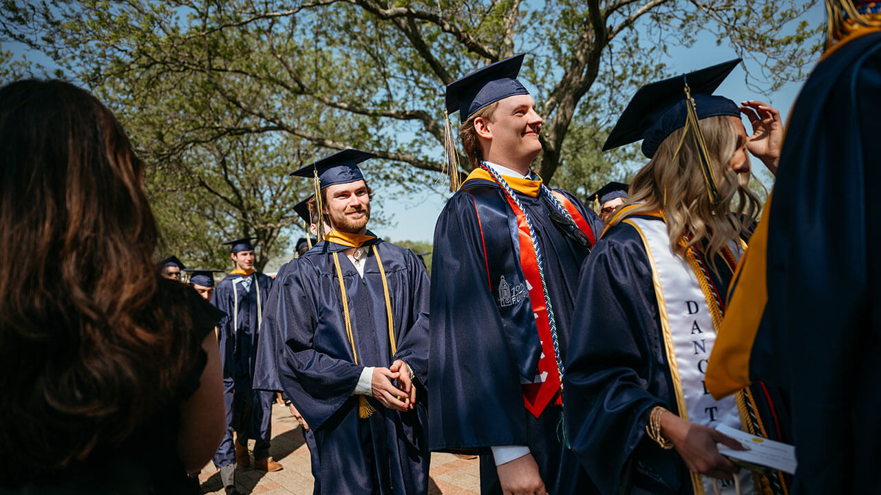 Graduates processing into their seats