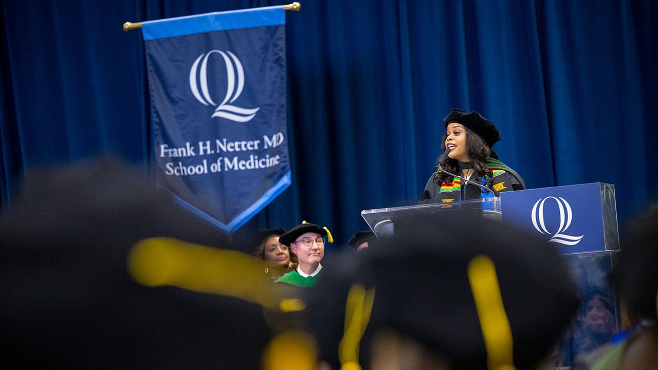 graduating student speaker gives her speech to the audience of graduates