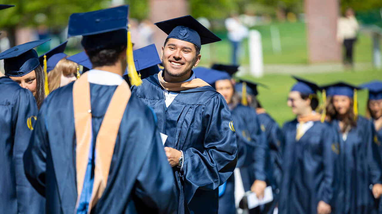 MBA graduates share excited smiles on commencement day.