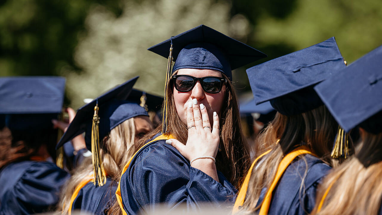A grad blowing a kiss