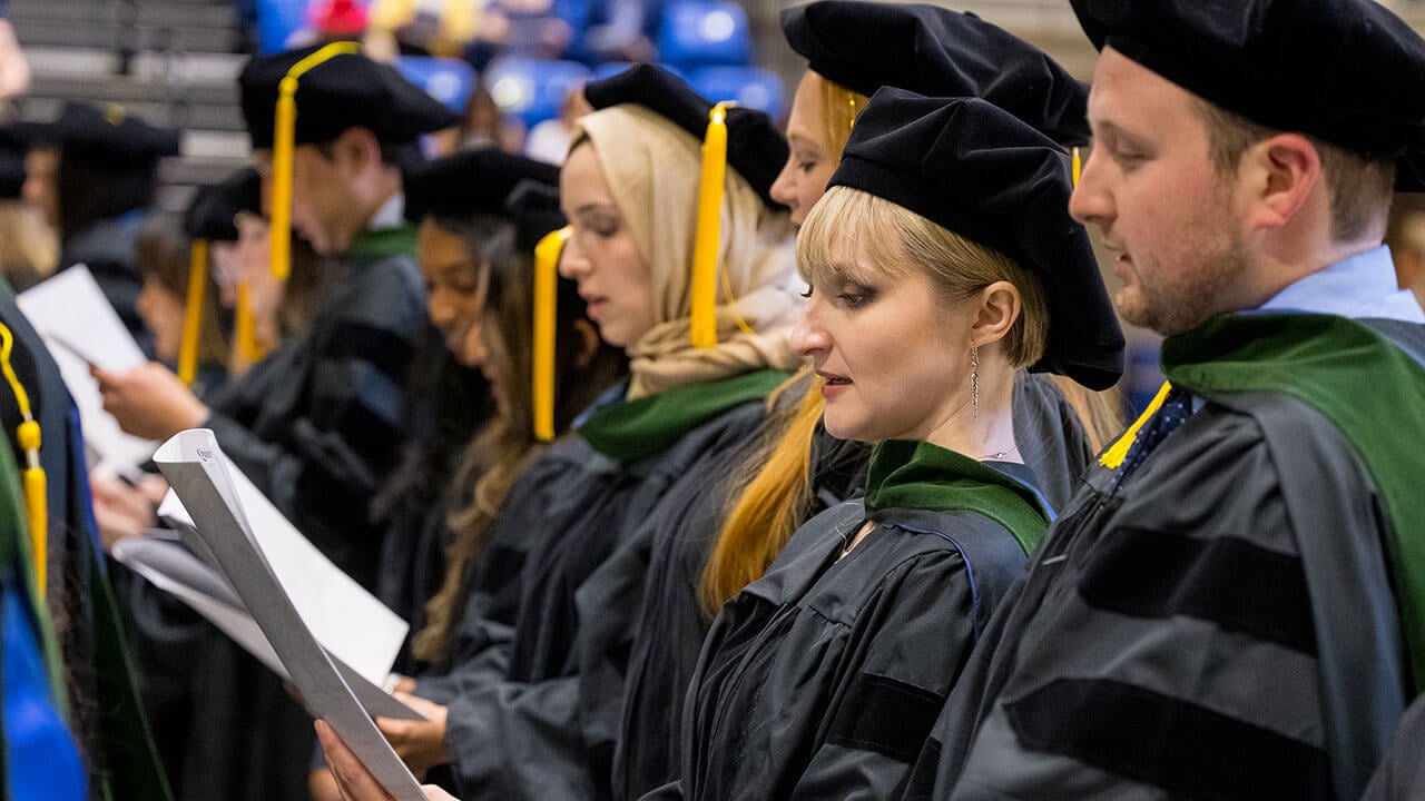 row of graduates reads out the oath of netter doctors from their programs