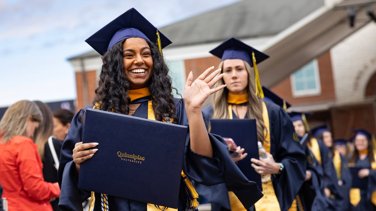 Student waves to the crowd