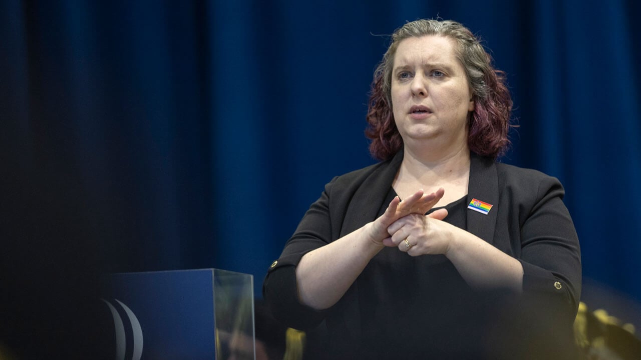 ASL translator communicating to the audience during Law Commencement