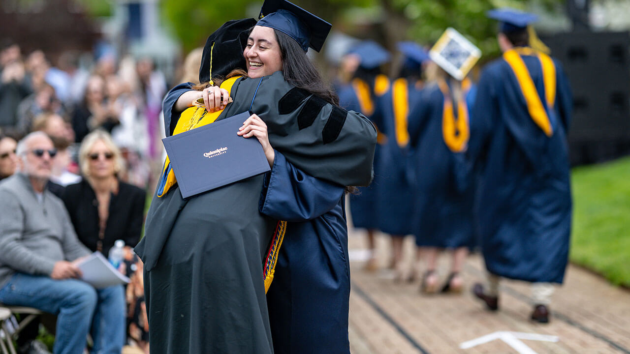 graduate hugs professor