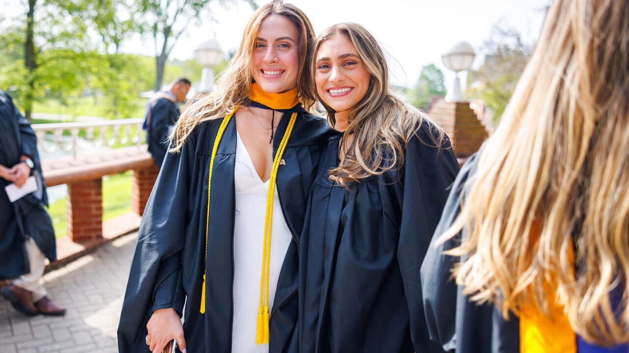 Business graduates posing for photo prior to commencement