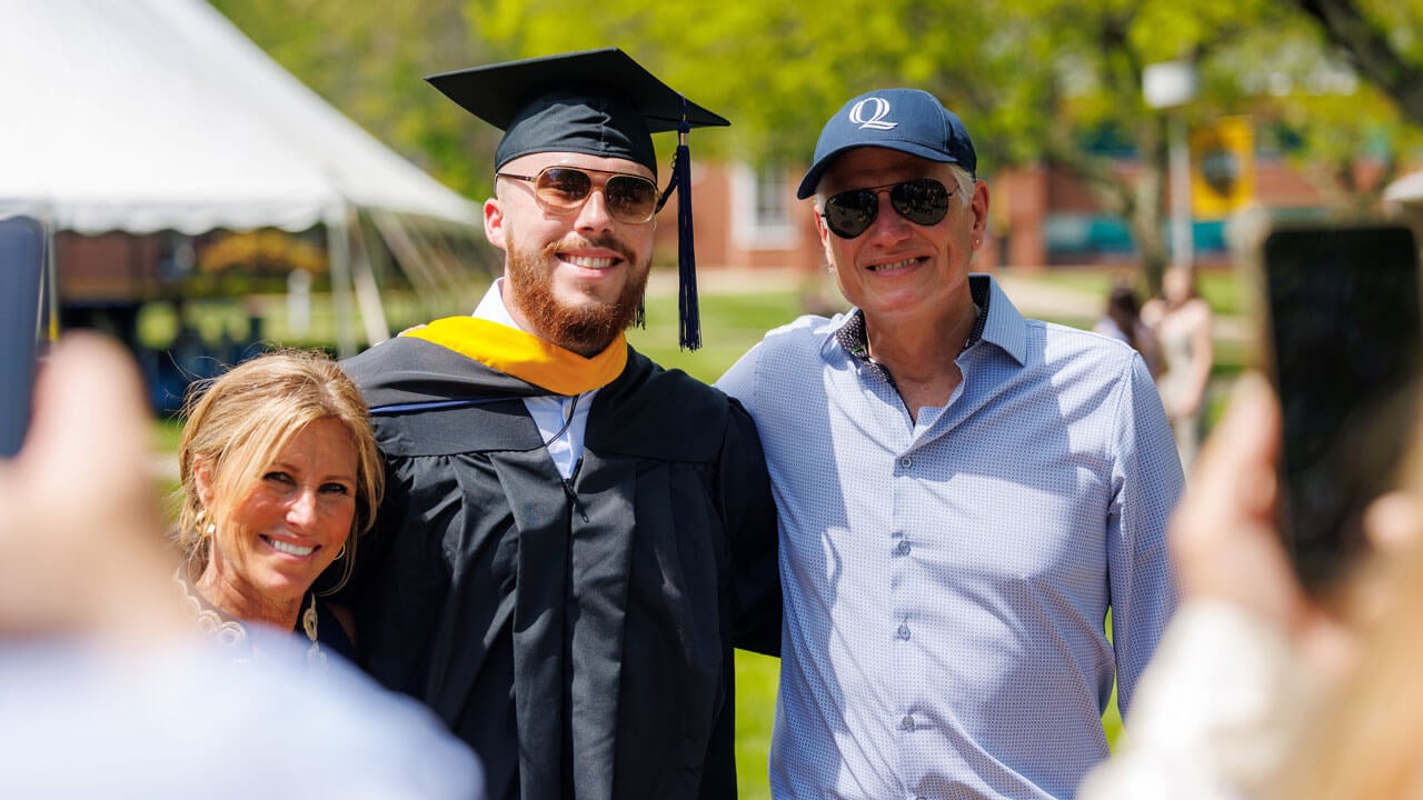 Graduate student gathered with family for a photo during graduation