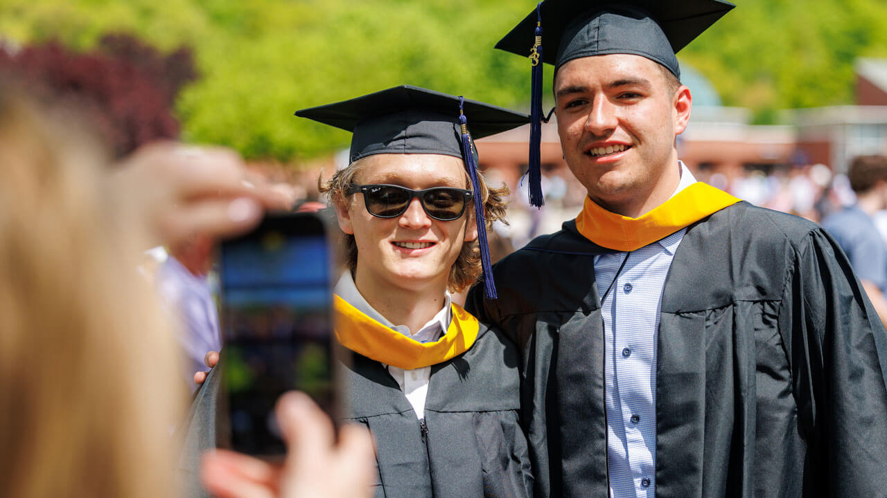 Two graduates posing together for a photo