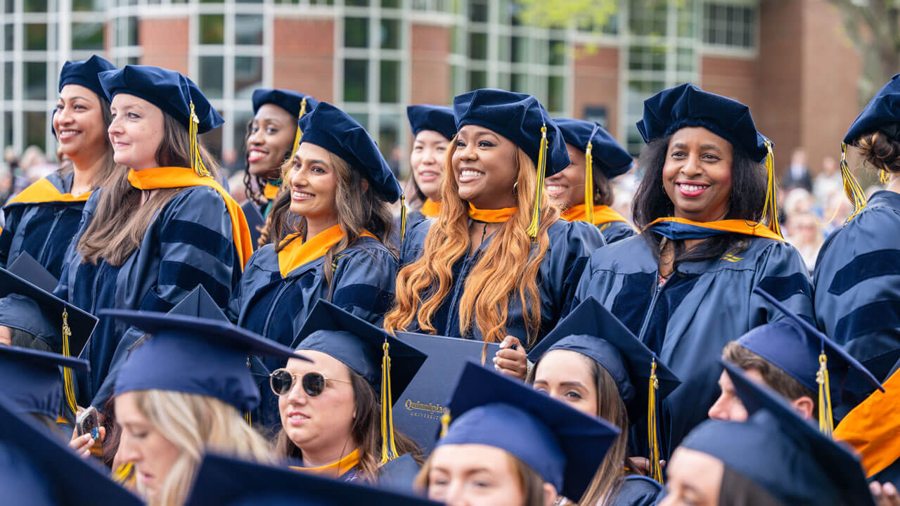 Quinnipiac graduates smile towards Commencement stage