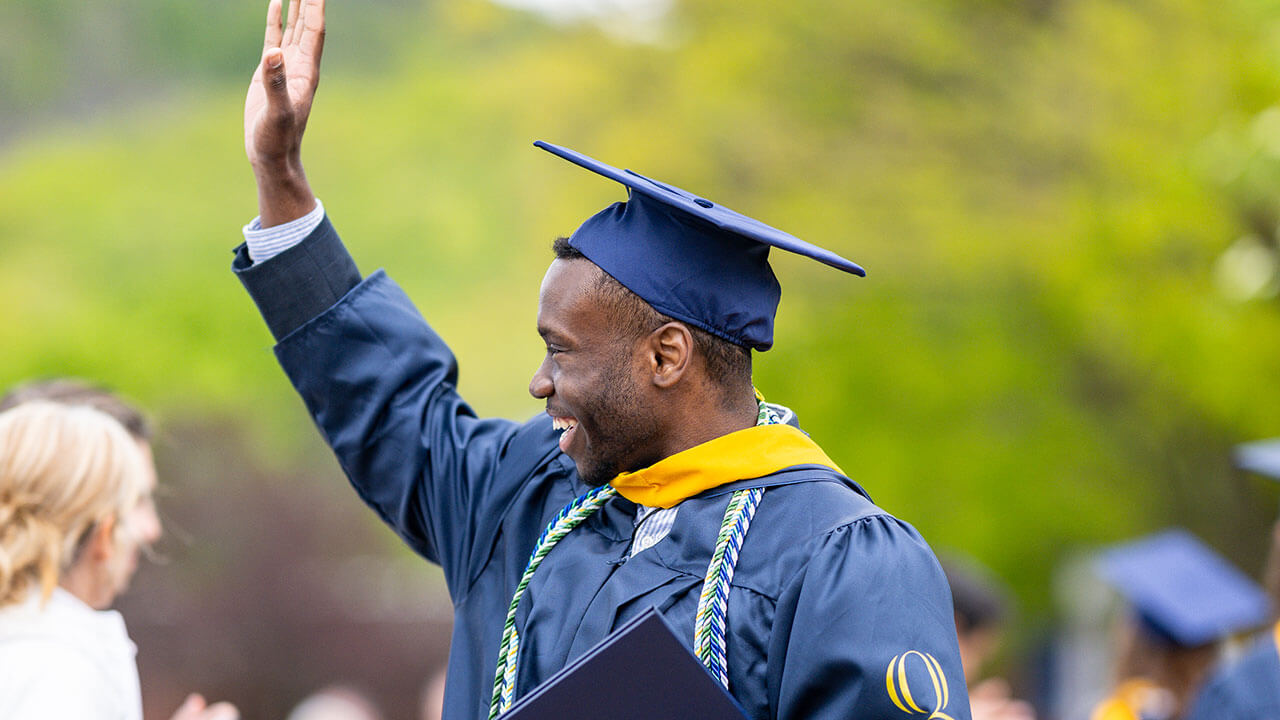 graduate waves into audience