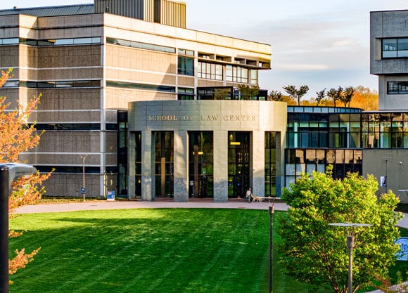 Exterior view of Quinnipiac University’s School of Law Center on the North Haven Campus, surrounded by a lush green lawn.