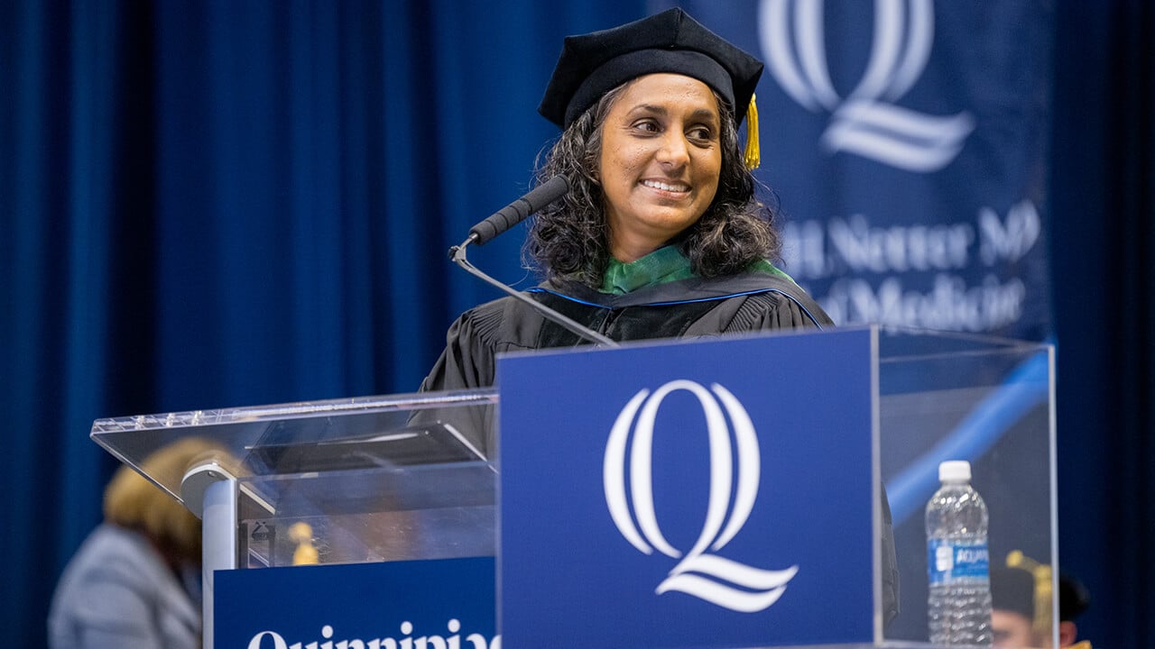 Graduate stands at podium on stage