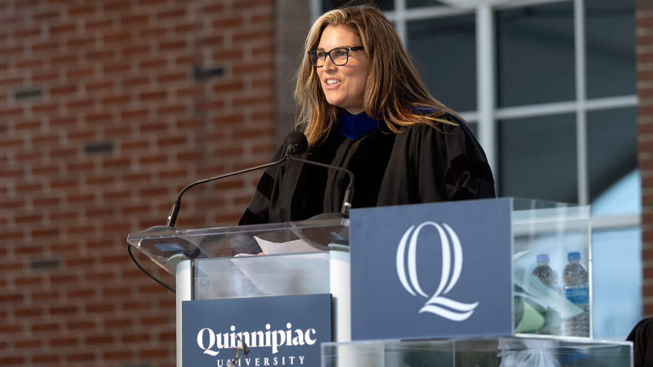 Jeanna Doherty speaks from the podium on the Commencement stage