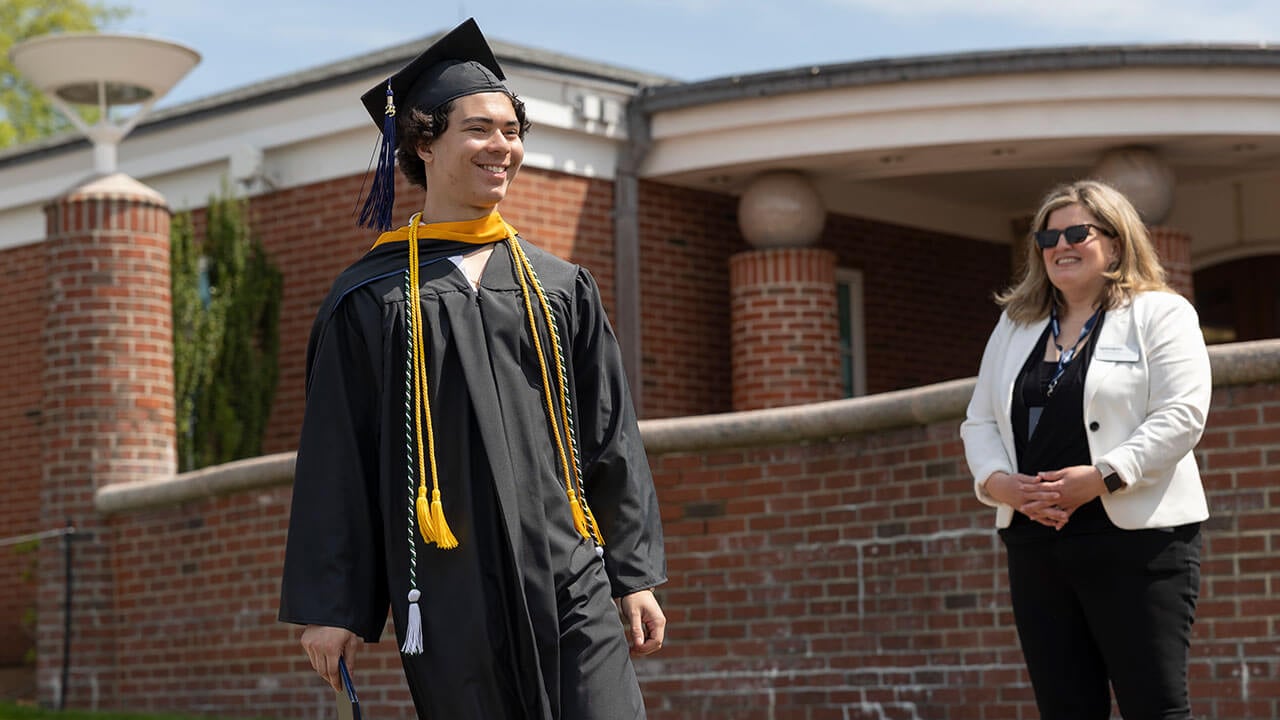 Graduate walks toward the stage