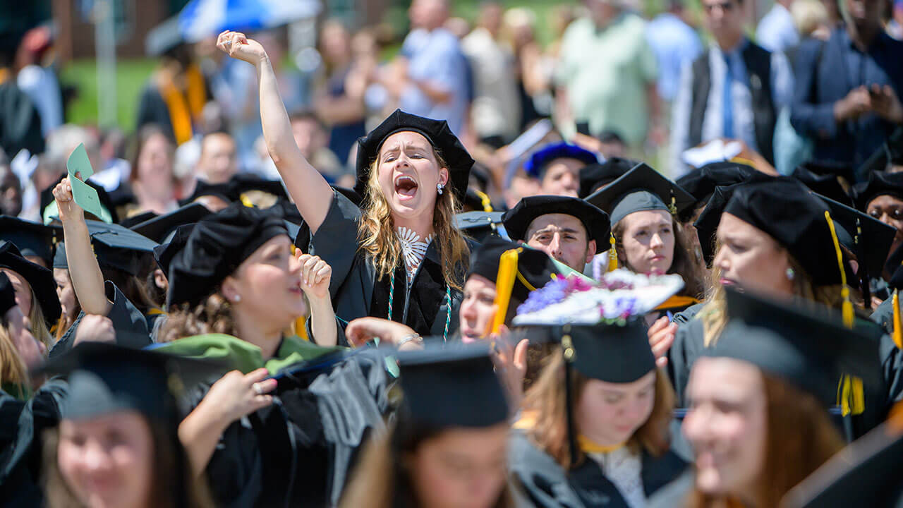 Graduate student cheers in the audience