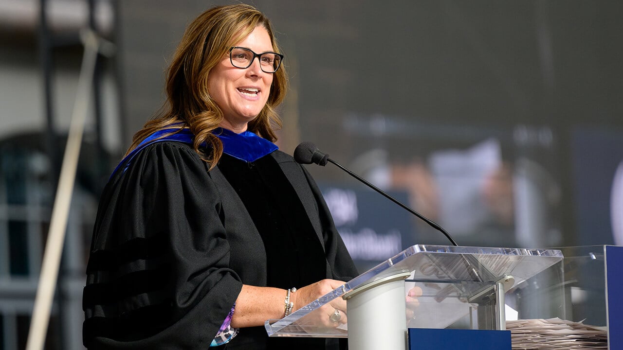 Jenna Doherty '94, Chair of the Alumni Association Board, welcomes graduates to the alumni family