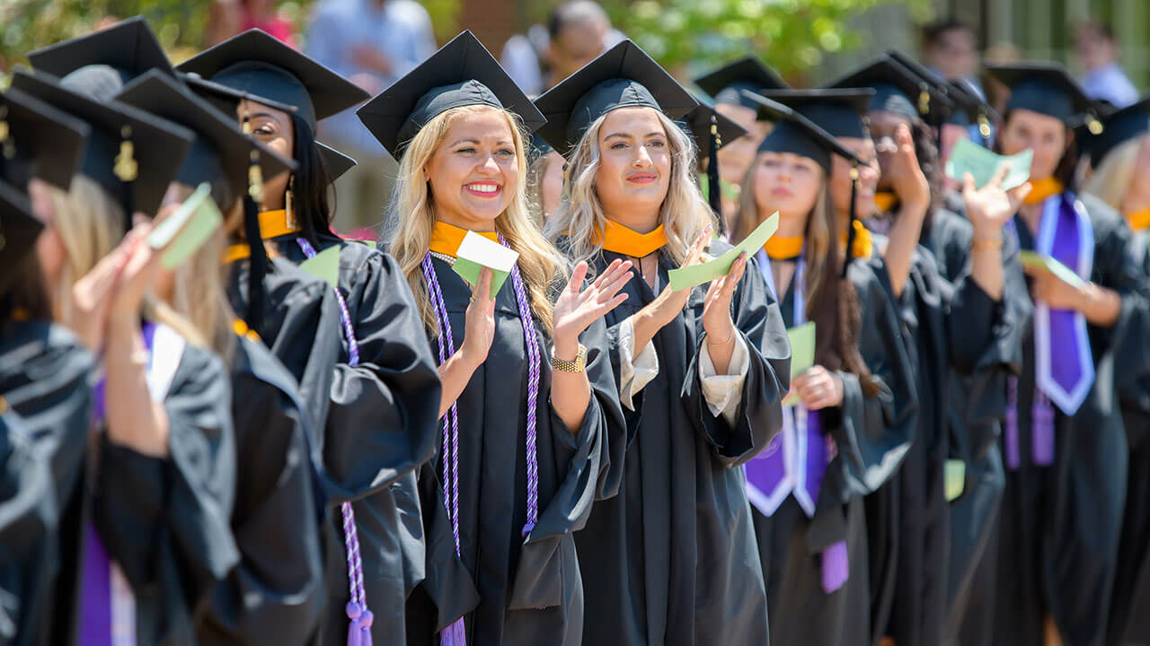 Graduate students applaud during the Commencement Ceremony