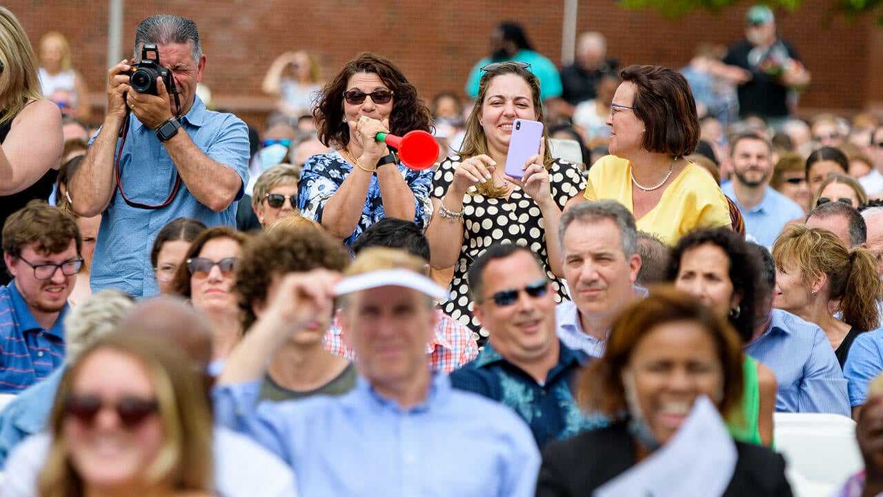 Parents cheering and taking photos at Commencement