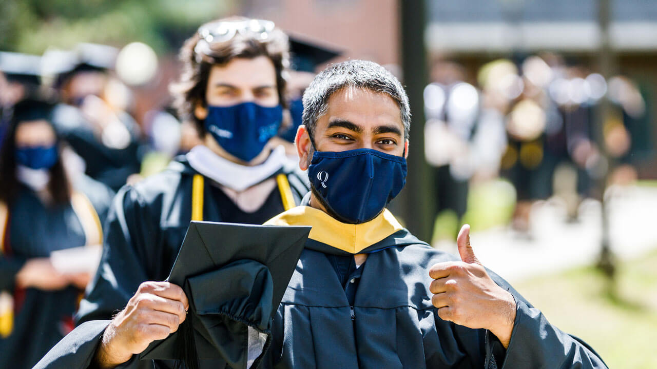 Graduate giving thumbs up