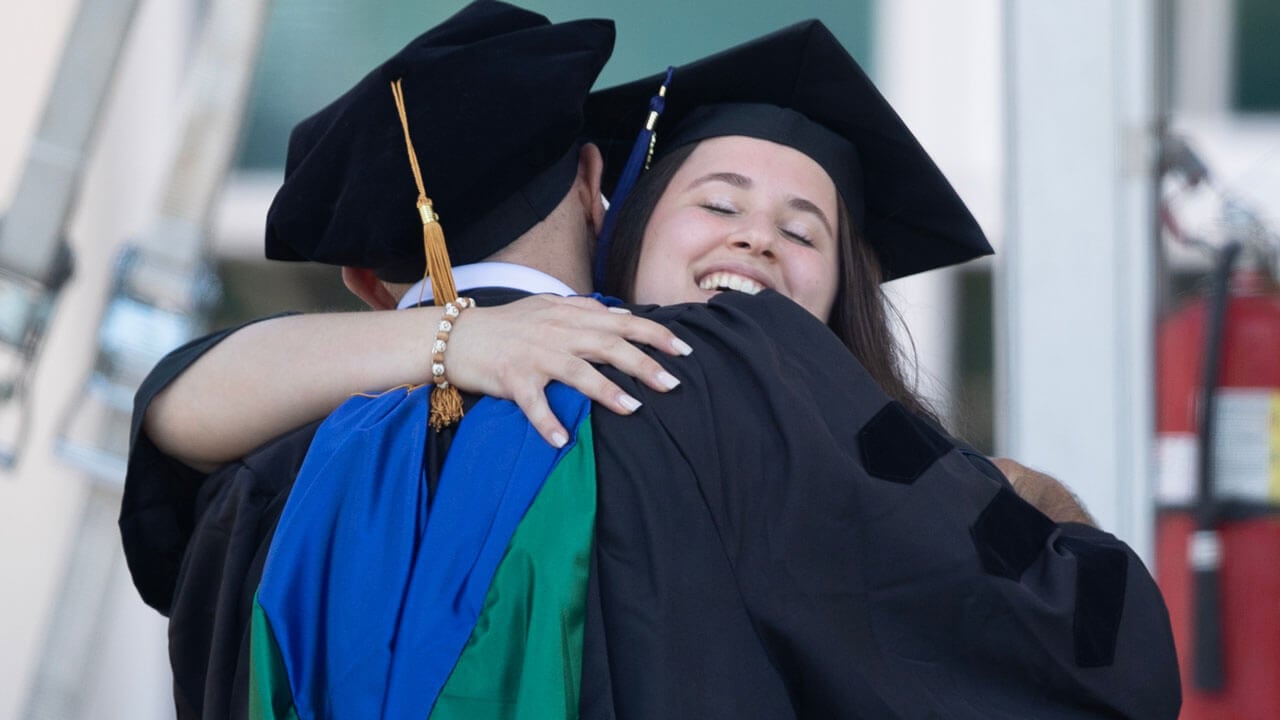 Graduate hugging in celebration