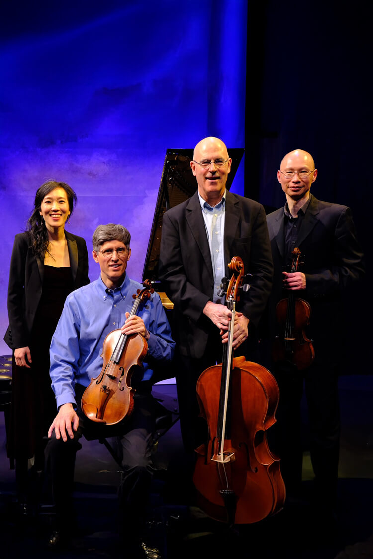 Brahms Piano Quartet posing with their instruments