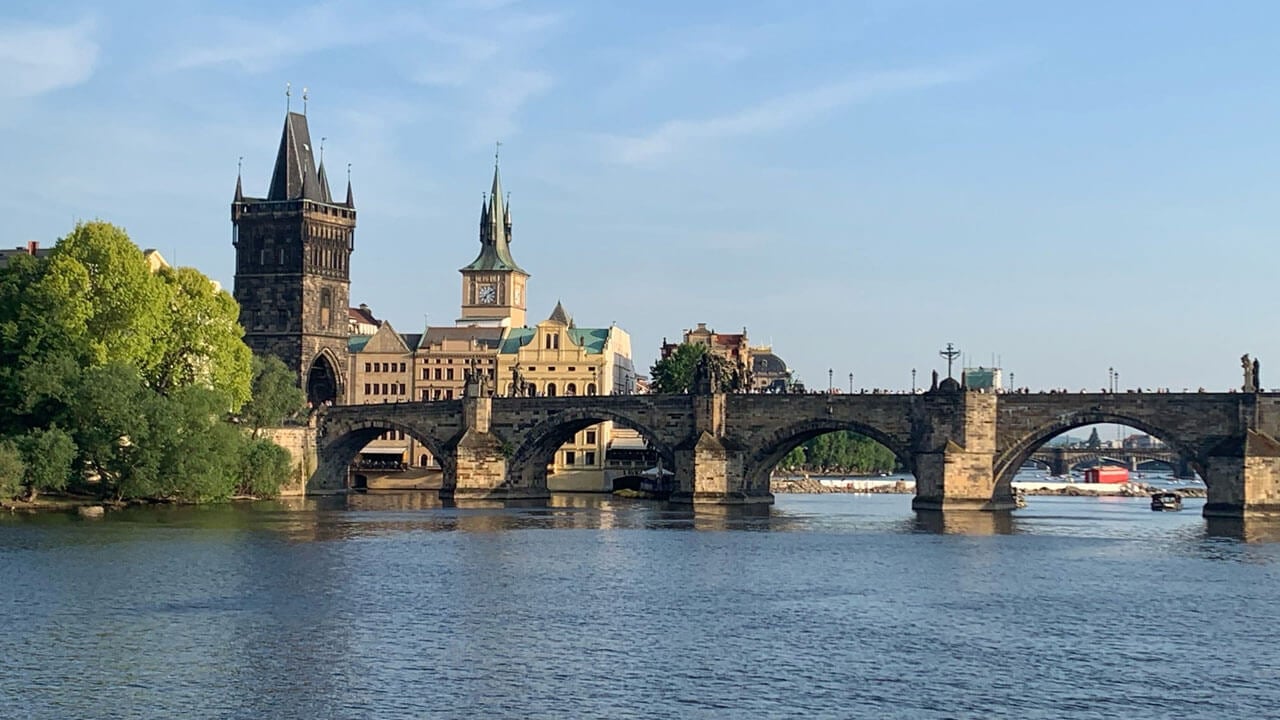 Towers in the background with the sun glistening on the river