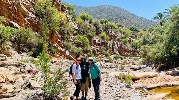 Elyssa Wrubel stands with 2 other Quinnipiac students in the desert in Morocco