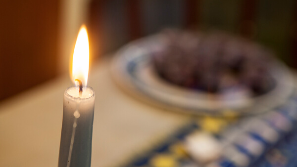 A glowing, lit candle