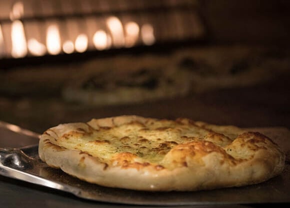 Pizza cooking in a brick oven